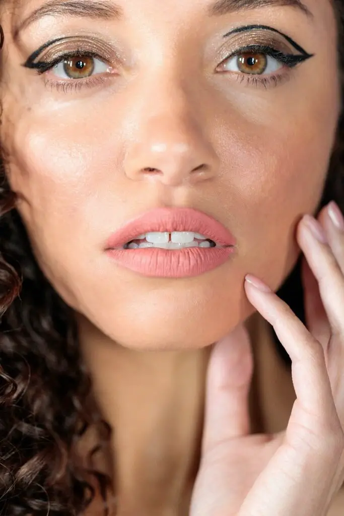 close-up of a beautiful woman wearing eyelash glue eyeliner