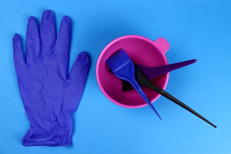 hair bleaching kit - bowl, brushes, gloves on a blue background